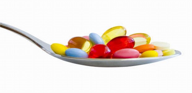 Colorful pills on spoon